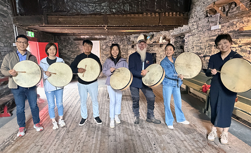 Ireland-China cultural exchange participants holding traditional frame drums
